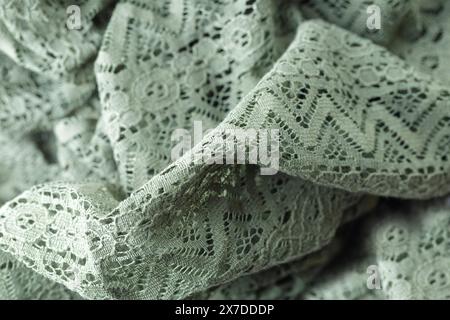 A green knit blanket with a pattern of zigzags. The blanket is soft and cozy, perfect for snuggling up on a cold day Stock Photo