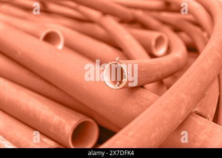 Mountain of Industrial pipes toned in peach fuzz - the fashionable color of 2024 year Stock Photo