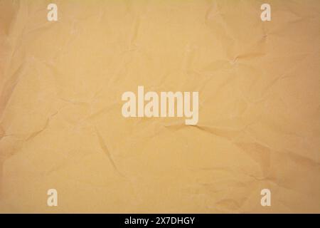 Beige color background with little wrinkles. Beige color recycled craft paper texture as background. Stock Photo