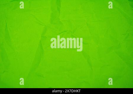 Green color background with little wrinkles. Green recycled craft paper texture as background. Stock Photo