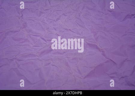 Purple background with dense wrinkles. Purple recycled kraft paper texture as background. Stock Photo