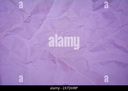 Purple color background with little wrinkles. Purple recycled craft paper texture as background. Stock Photo