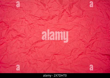 Red background with dense wrinkles. Red recycled kraft paper texture as background. Stock Photo