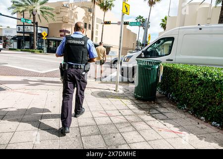 Miami Beach Florida,Collins Avenue,Brinks armored truck van,armed guard,Black African man weapon gun,carrying money bag,wearing bulletproof vest,dange Stock Photo