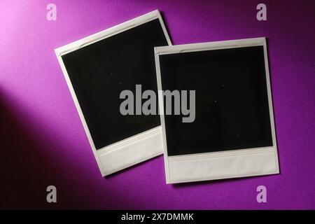 Two blank cards on purple background. Blank square photo frame on wall copy space download Stock Photo