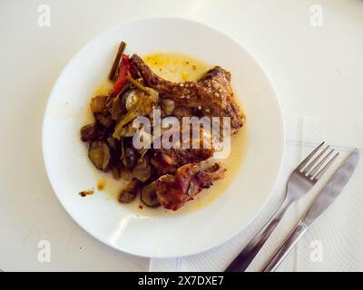 Roasted rabbit served with potato and vegetables Stock Photo