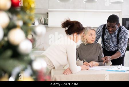 Couple discussing testament with elderly woman Stock Photo