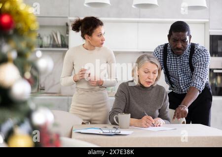 Couple discussing testament with elderly woman Stock Photo