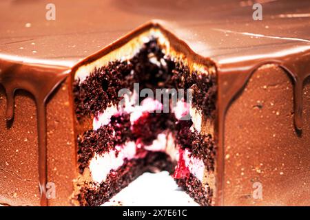 beautiful chocolate cake with sponge dough with a cut piece on display Stock Photo