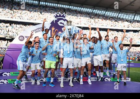 Manchester, UK. 20th May, 2024. Players of Manchester City celebrate with the Premier League trophy after the English Premier League football match between Manchester City and West Ham United in Manchester, Britain, on May 19, 2024. Credit: Xinhua/Alamy Live News Stock Photo