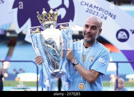 Manchester, UK. 20th May, 2024. Manchester City's manager Pep Guardiola celebrates with the Premier League trophy after the English Premier League football match between Manchester City and West Ham United in Manchester, Britain, on May 19, 2024. Credit: Xinhua/Alamy Live News Stock Photo