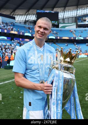 Manchester, UK. 20th May, 2024. Erling Haaland of Manchester City celebrates with the Premier League trophy after the English Premier League football match between Manchester City and West Ham United in Manchester, Britain, on May 19, 2024. Credit: Xinhua/Alamy Live News Stock Photo