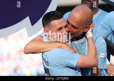 Manchester, UK. 20th May, 2024. Manchester City's manager Pep Guardiola (R) celebrates with Phil Foden after the English Premier League football match between Manchester City and West Ham United in Manchester, Britain, on May 19, 2024. Credit: Xinhua/Alamy Live News Stock Photo