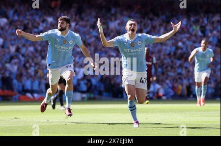 Manchester, UK. 20th May, 2024. Phil Foden (Front) of Manchester City celebrates after scoring during the English Premier League football match between Manchester City and West Ham United in Manchester, Britain, on May 19, 2024. Credit: Xinhua/Alamy Live News Stock Photo