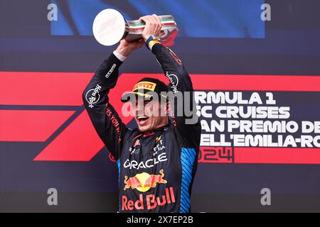 Imola, Italy. 19th May, 2024. Red Bull Racing's Dutch driver Max Verstappen celebrates with the trophy on the podium after the Formula One Emilia Romagna Grand Prix at the Autodromo Internazionale Enzo e Dino Ferrari race track in Imola, Italy, May 19, 2024. Credit: Qian Jun/Xinhua/Alamy Live News Stock Photo