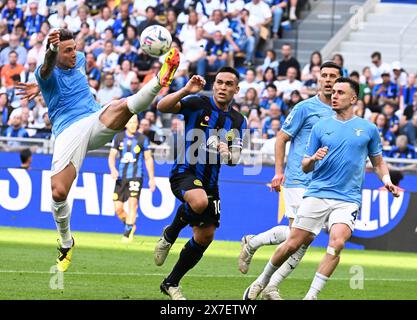 Milan, Italy. 19th May, 2024. Lazio's Luca Pellegrini (L) vies for the ball during a Serie A football match between Inter Milan and Lazio in Milan, Italy, May 19, 2024. Credit: Alberto Lingria/Xinhua/Alamy Live News Stock Photo