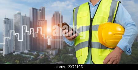 Civil engineer architect Using a smartphone to communicate and give orders to the construction team, Engineer building concept, Background for constru Stock Photo