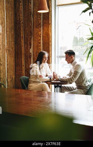 Casual Business Meeting Between Colleagues at a Cozy Cafe During Daytime Stock Photo