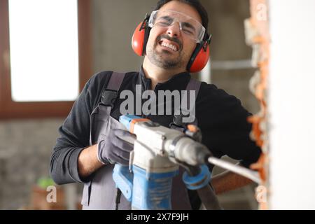 Construction worker is suffering backache after accident in a house renovation Stock Photo