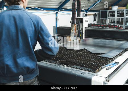 Steel worker on CNC plasma cutter machine, industry and technology. High quality photo Stock Photo