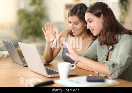 Two tele workers having video call with laptop at home Stock Photo