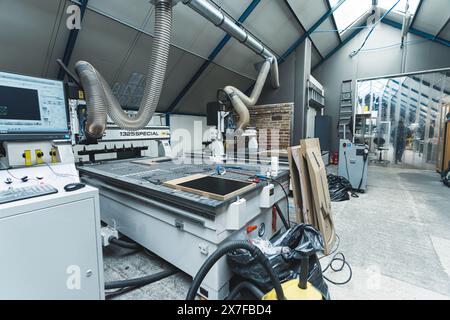 view of the modern machines at the factory, industrial concept, milling machine and MDF board molds for guitars. High quality photo Stock Photo