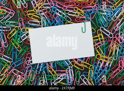 View from above of a Background with colorful paper clips and paper with copy space Stock Photo