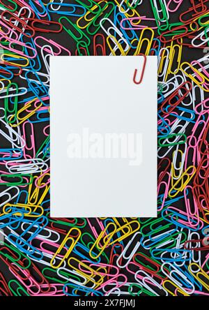 View from above of a Background with colorful paper clips and paper with copy space Stock Photo