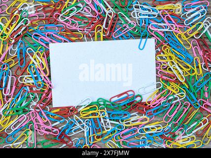 Background with colorful paper clips and paper with copy space Stock Photo