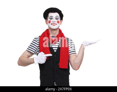 Funny mime artist pointing at something on white background Stock Photo