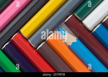 Colored pencils folded at an angle. Geometric pattern of pencils close-up Stock Photo