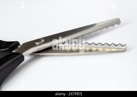 Special tailor's scissors with serrated zigzac edge on white background Stock Photo