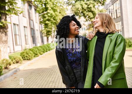 Two attractive and diverse women in cozy casual attire standing next to each other. Stock Photo