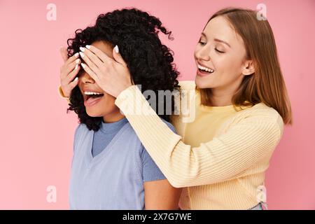 Two women in casual attire laughing and spending time together. Stock Photo
