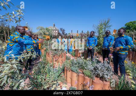 Royal Hospital, Chelsea, London, UK. 20th May, 2024. Press and VIP day at the RHS Chelsea Flower Show 2024 which opens to the public from 21 May-25 May. Image: Ghanaian Methodist Fellowship-UK Choir in traditional dress sing in the World Child Cancer's Nurturing Garden. Credit: Malcolm Park/Alamy Live News Stock Photo