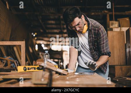 professional carpenter man hand working make wooden handcraft furniture master workpiece fine detail artisan with wood workshop. Stock Photo