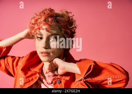 A woman with pink hair poses confidently. Stock Photo