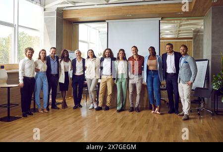 Group portrait of diverse, friendly and successful team working together in modern business center. Stock Photo