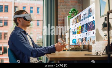 Young Handsome Man is Watching Videos on Online Streaming Service. Creative Male Using VR Headset for Checking Social Media, Browsing Internet, Consuming Content. Urban City View from Big Window. Stock Photo
