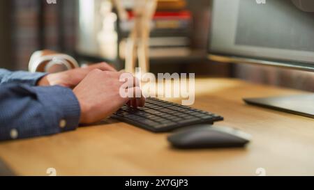 Close Up on Male Hands Working from Home on Desktop Computer, Typing on Keyboard. Student Making Homework Assignment, Studying for School Exams. Young Adult Checking Social Media. Stock Photo