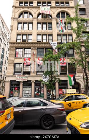 Manhattan, USA. 18th May, 2024. Banners protesting financial ties to Israel are seen hanging outside an administrative building of The New School, which student protesters occupying the building have renamed the “Lama Jamous Center” in Lower Manhattan, NY on Saturday, May, 18, 2024. Lama Jamous is a nine-year-old Palestinian aspiring journalist who amassed a large following on social media for her live reporting from Gaza since October 7th, 2023. (Photo by Cristina Matuozzi/ Credit: Sipa USA/Alamy Live News Stock Photo