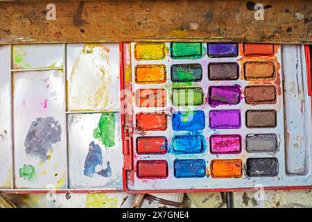 set of watercolor paints in a flatlay plastic box. The working process. authenticity Stock Photo