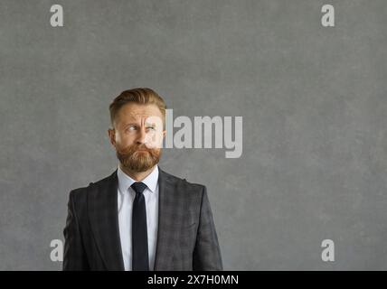 Businessman feeling nervous, upset and scared looking aside with funny face expression Stock Photo