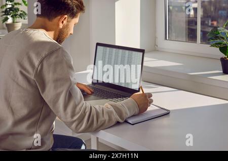 Businessman checking spreadsheet on computer screen in office Stock Photo