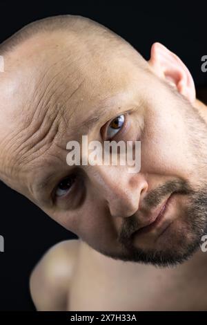 This portrait offers a glimpse into the soulful repose of a 45-year-old man. Stock Photo