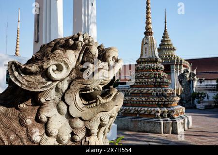 Thailand, Bangkok, Pranon Wat Pho, laying Buddha temple, stone dragon statue Stock Photo