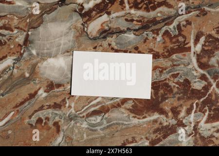 Horizontal business card mockup in sunlight from above. Colorful marble background. Red, white onyx texture. Template for design presentation Stock Photo