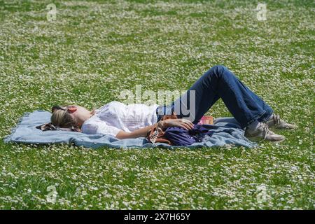 London, UK. 20 May, 2024.  A woman soaking the sunshine in Saint Jame's Park   with temperatures expected above 22celsisus Credit: amer ghazzal/Alamy Live News Stock Photo