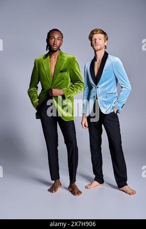 Two elegant multicultural men in stylish suits standing side by side. Stock Photo