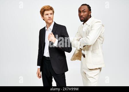 Two multicultural men in elegant suits stand side by side. Stock Photo